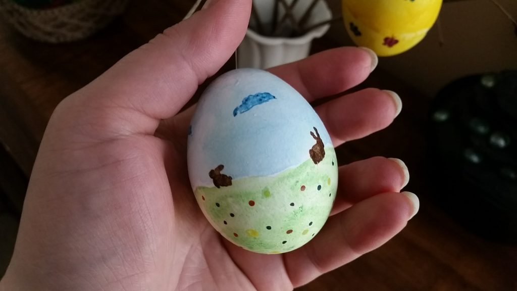 Easter eggs painted with watercolors and a bunny in the meadow design